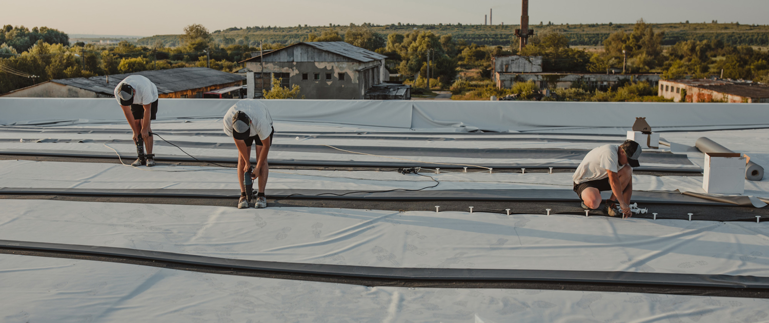 Construction Worker Drill With A Powerful Electric Drill Synthetic Membrane For A New Roof