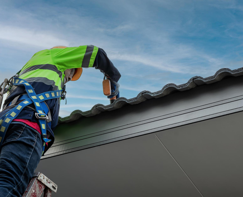 Worms Eye View Of A Roofer Working On A Roof