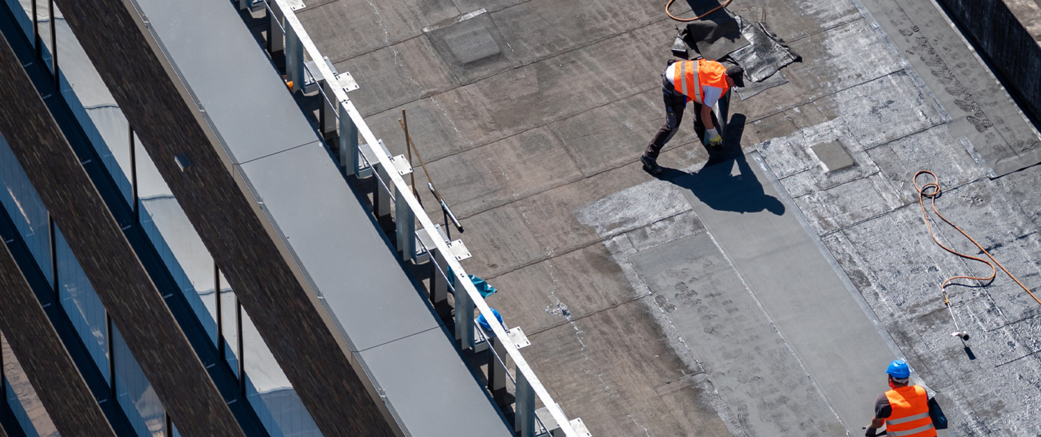 Birds Eye View Of A Roof Construction Site. Professional Bitumen Waterproofing On A Flat Building