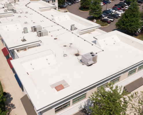 Sunny Mid Day Drone Images Of Tpo Roofing On Mid Size Commercial Buildings